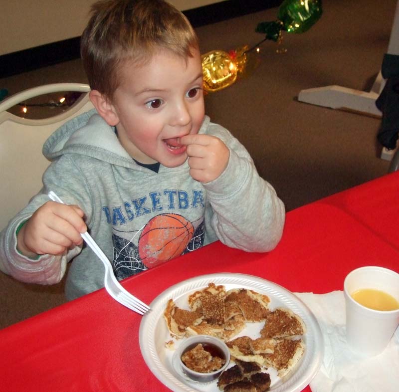 photo of boy eating breakfast